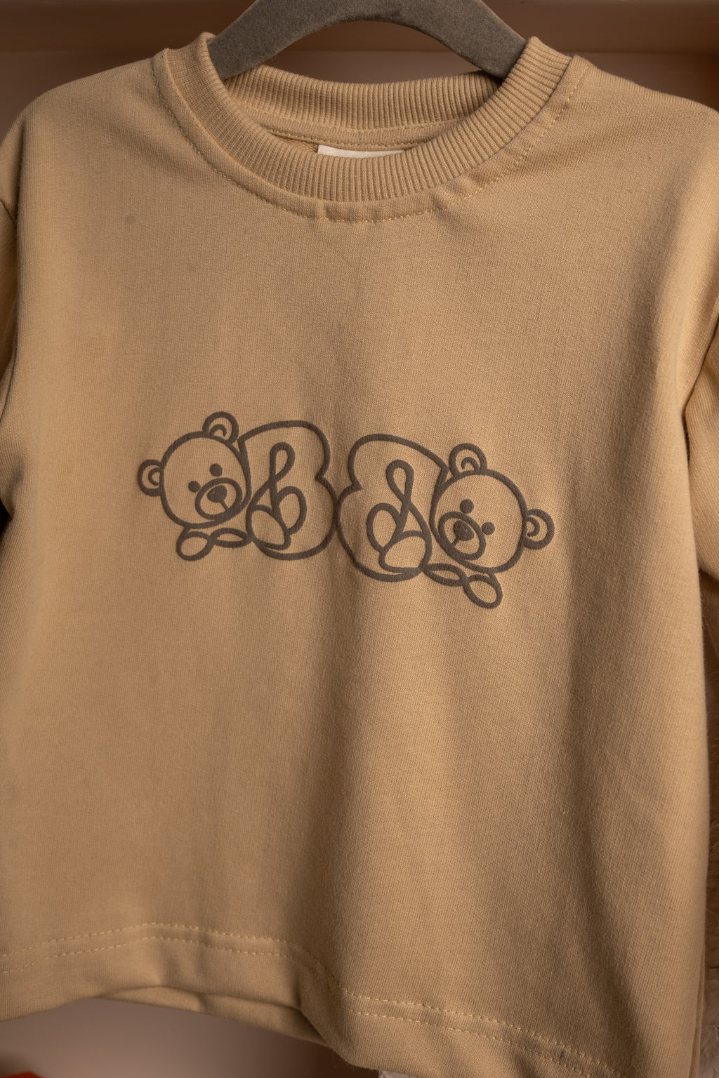 Luxury beige sweatshirt with twin teddy bear graphic on soft fabric, elegant casual wear